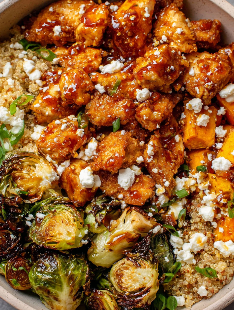 A bowl of chicken with sauce and vegetables.