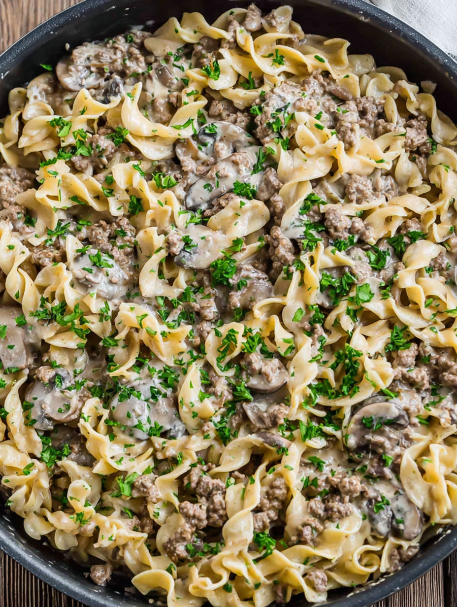 A bowl of noodles with mushrooms and meat.