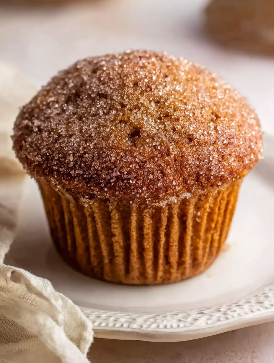 A muffin with a sugar and cinnamon topping.