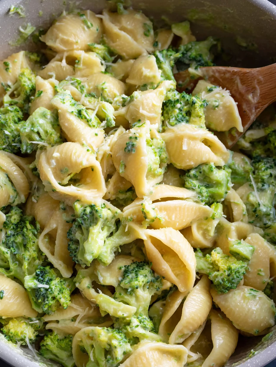 A close up of a bowl of pasta with broccoli.