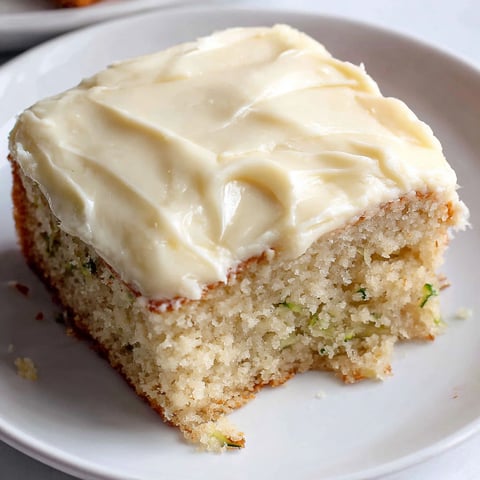 A slice of zucchini cake on a plate.