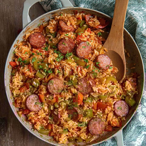 A bowl of rice and sausage.