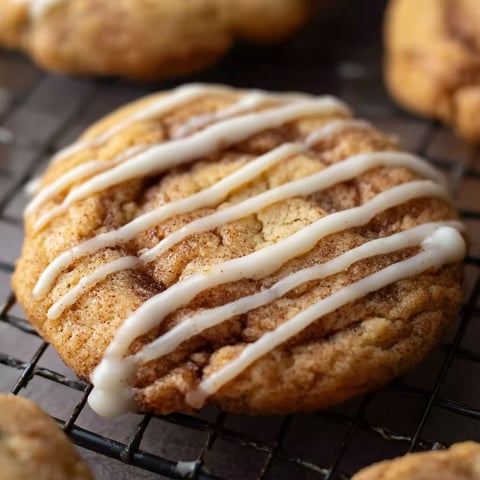 A cinnamon roll cookie with white icing.