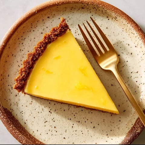 A slice of lemon butter pie on a plate.