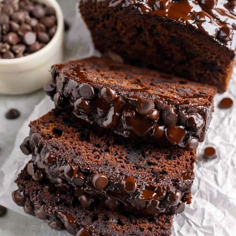 A slice of chocolate cake with chocolate drizzle.