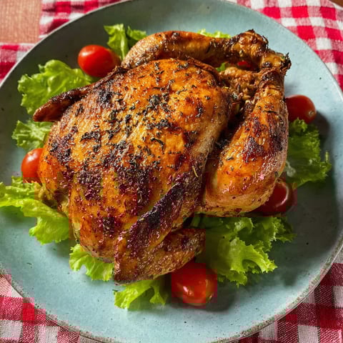 A plate of chicken with tomatoes and lettuce.