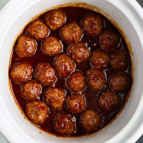 A pot of meatballs in a brown sauce.