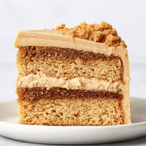 A slice of Biscoff cake on a plate.