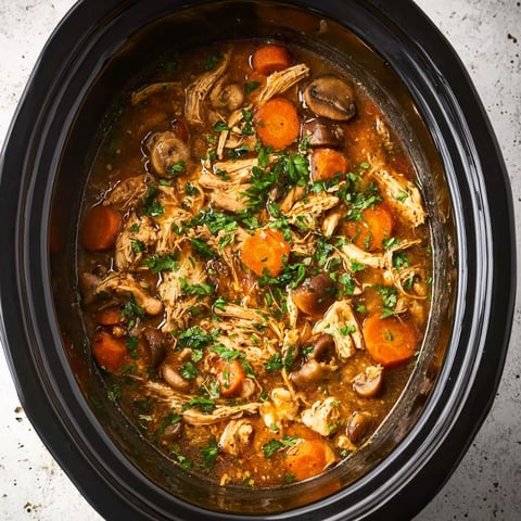 A crockpot filled with chicken and vegetables.